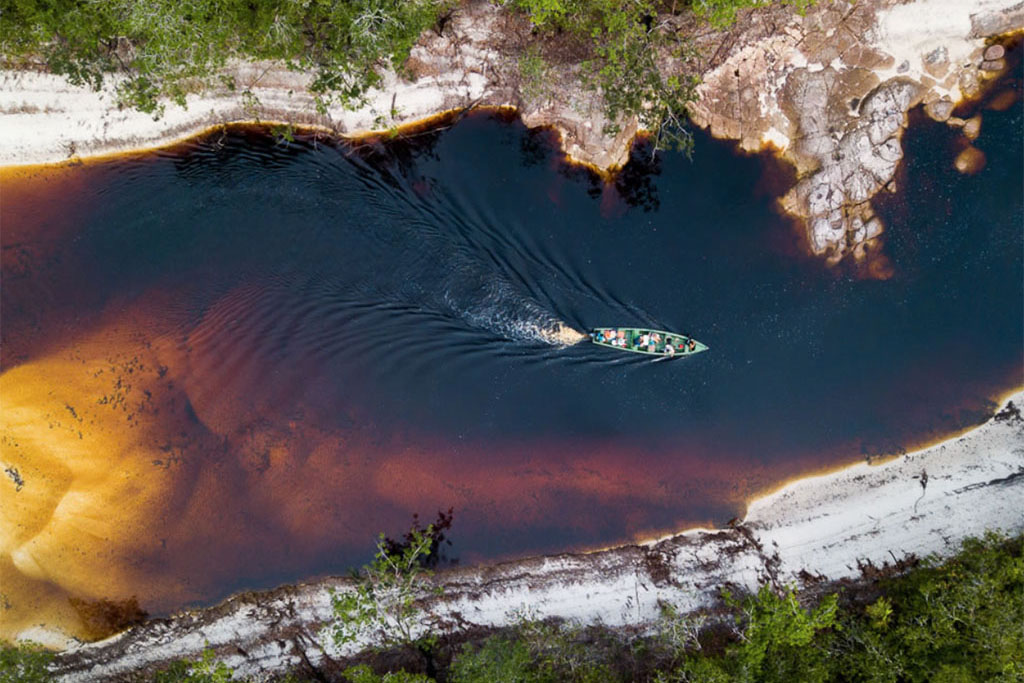 amazon expeditions - a boat in the negro river in amazon rainforest